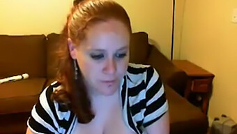 Big-Breasted Redhead Shows Off On Camera