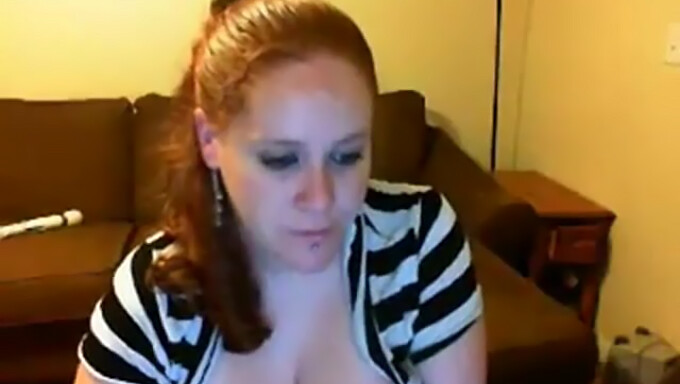 Big-Breasted Redhead Shows Off On Camera